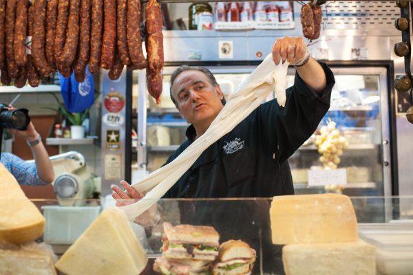 Dave Greco makes fresh mozzarella at Mike's Deli at the Arthur Avenue Retail Market. (Crystal Shi/The Epoch Times)