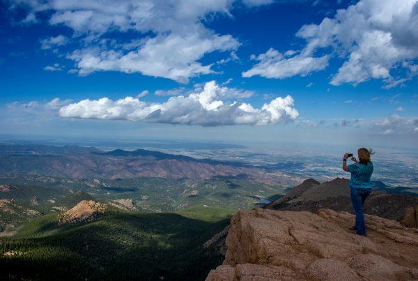 A woman takes a picture at the top of Pikes Peak mountain in the Front Range of the Rocky Mountains within Pike National Forest near Springs, Colo.(Joe Klamar/AFP/Getty Images)