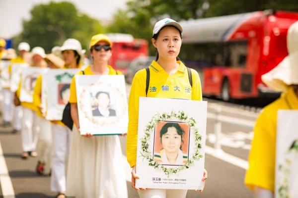 Falun Gong practitioners in Washington, D.C. march in a parade to commemorate those who have died since the persecution in China began on July 20, 1999. (Benjamin Chasteen/The Epoch Times)
