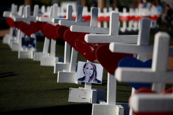 A photograph hangs from one of the 58 white crosses set up for the victims of the Route 91 music festival mass shooting in Las Vegas, Nevada, U.S., October 5, 2017. (Reuters/Chris Wattie)