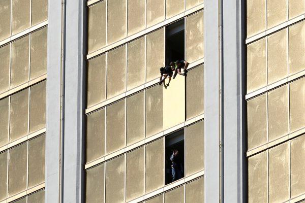 Workers board up a broken window at the Mandalay Bay hotel, where shooter Stephen Paddock conducted his mass shooting along the Las Vegas Strip, in Las Vegas, Nevada, U.S., October 6, 2017. (Reuters/Chris Wattie)