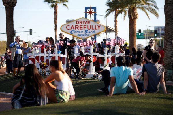 People gather to look at white crosses set up for the victims of the Route 91 Harvest music festival mass shooting in Las Vegas, Nevada, U.S., October 6, 2017. (Reuters/Chris Wattie)
