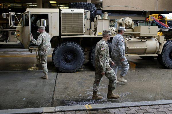 Members of the Louisiana National Guard walk past a high water vehicle at the Superdome as Hurricane Nate approaches the U.S. Gulf Coast in New Orleans, Louisiana, U.S. on October 7, 2017. (Reuters/Jonathan Bachman)