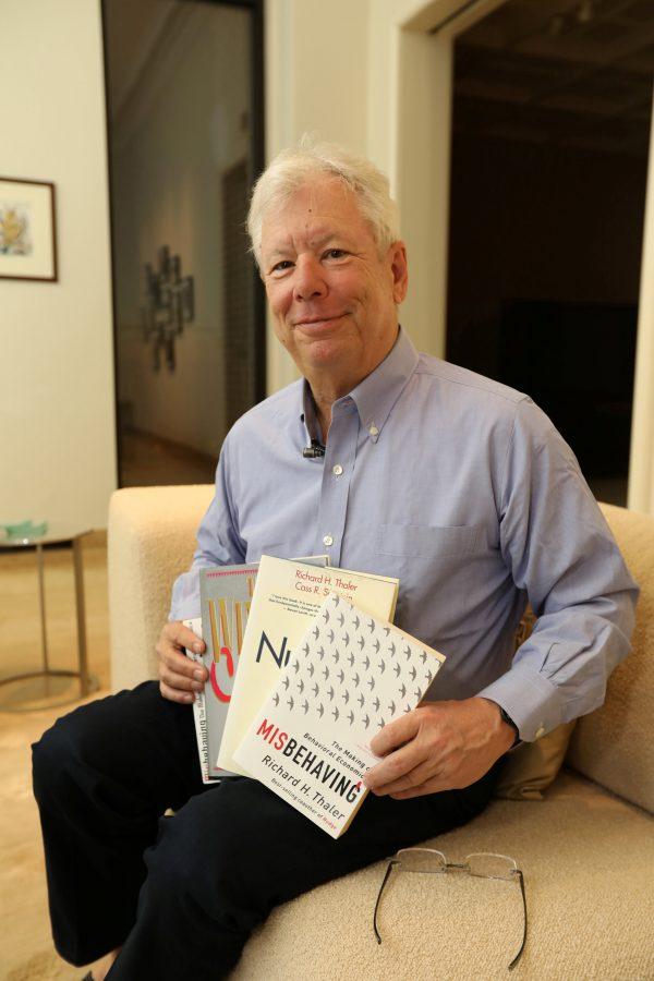 University of Chicago Booth School of Business economist Richard Thaler poses with his books after winning the 2017 Nobel Economics Prize, at his apartment in Chicago, Illinois on Oct. 9, 2017. (University of Chicago/Anne Ryan/Handout via REUTERS)