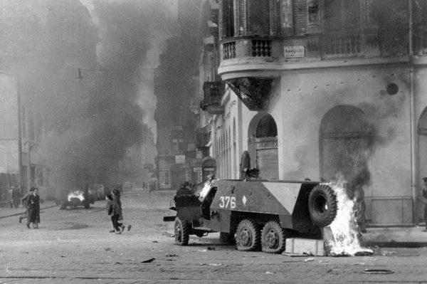 An armored vehicle burns in the streets of Hungary during the 1956 uprising against communism (Házy Zsolt via Wikimedia Commons)
