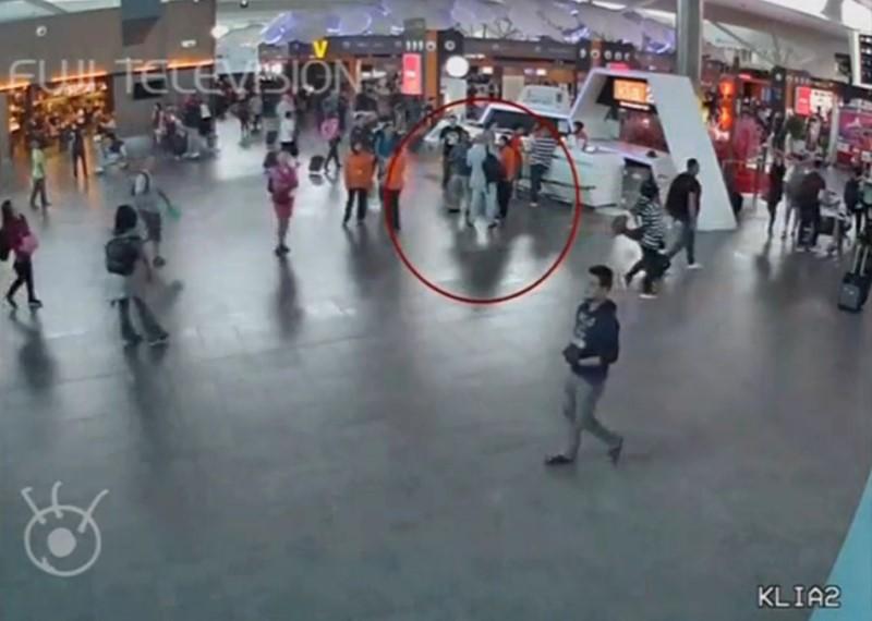 A still image from a CCTV footage appears to show a man purported to be Kim Jong Nam (circled in red) talking to airport staff, after being accosted by a woman in a white shirt, at Kuala Lumpur International Airport in Malaysia on Feb. 13, 2017. (FUJITV/via Reuters TV)