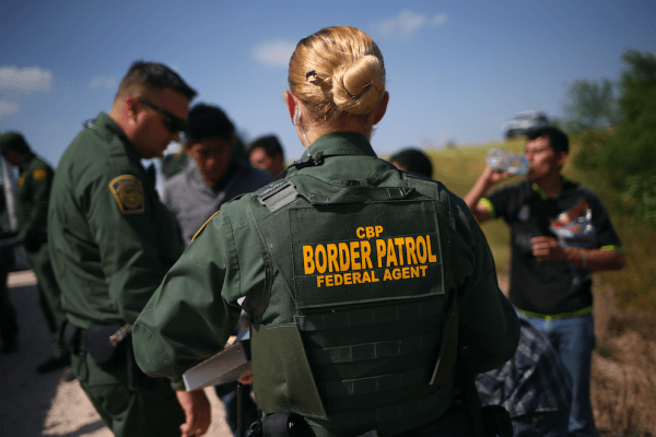 U.S. Border Patrol agents detain illegal immigrants after they crossed the border from Mexico into the United States in McAllen, Texas, on Aug. 7, 2015. (John Moore/Getty Images)