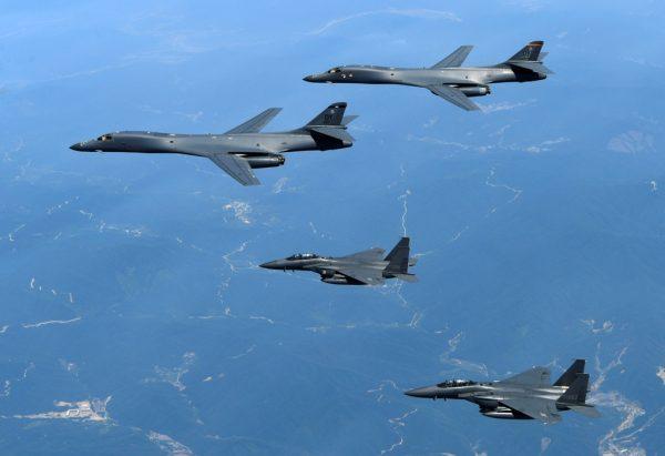 In this June 20, 2017 file photo provided by South Korean Defense Ministry, U.S. Air Force B-1B bombers, top, and second from top, and South Korean fighter jets F-15K fly over the Korean Peninsula, South Korea. (South Korean Defense Ministry via AP, File)