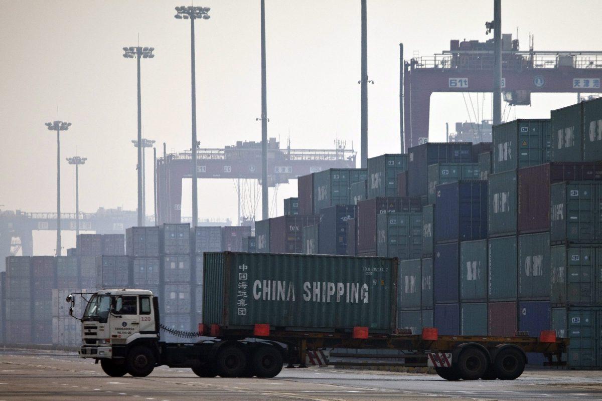 A truck transports a container to be loaded onto a ship at a port in Tianjin, China. (Alexander F. Yuan/AP Photo)