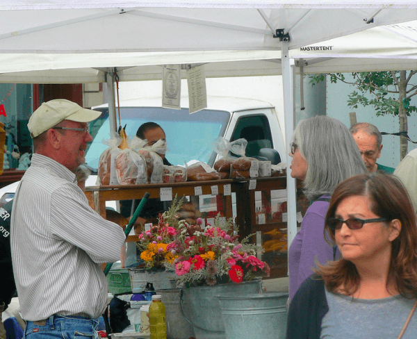 Old good human interaction is another perk of shopping at the farmers market. Small farmers are deeply and personally invested in the health of the land where they raise their families. Ask them how they farm (Daniel Babay).