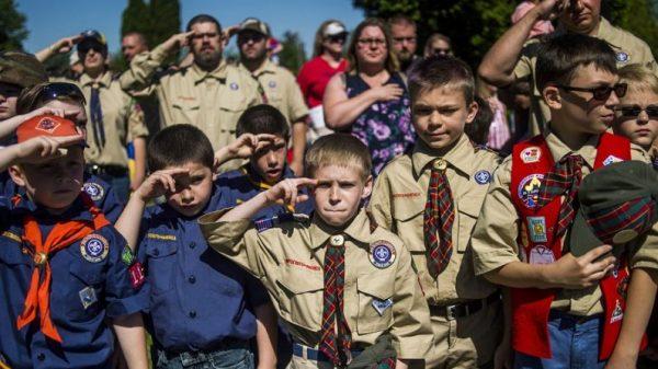 Boy Scouts and Cub Scouts salute during a Memorial Day ceremony in Linden, Mich., on Oct. 11, 2017. (Jake May/File/The Flint Journal - MLive.com via AP)
