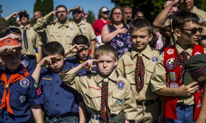 Boy Scouts and Cub Scouts salute during a Memorial Day ceremony in Linden, Mich., on Oct. 11, 2017. (Jake May/The Flint Journal - MLive.com via AP)