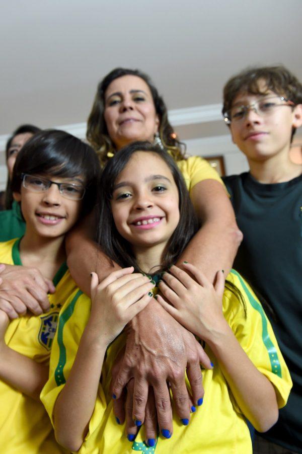 Members of the da Silva family, Pedro (L), Silvana (top C), Maria (bottom C) and Pedro, who were all born with 12 fingers, pose in their home in Brasilia, on June 21, 2014. (AFP PHOTO/ EVARISTA SA)