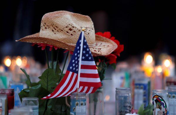 FILE PHOTO - A hat rests on flowers in a makeshift memorial during a vigil marking the one-week anniversary of the October 1 mass shooting in Las Vegas, Nevada U.S. October 8, 2017. (Reuters/Las Vegas Sun/Steve Marcus)