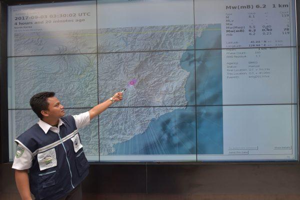 An Indonesian official at Indonesia's Meterological, Climatological and Geophysical Agency (BMKG) points to a map of North Korea showing where the agency recorded a 6.2 magnitude earthquake caused by a North Korean nuclear test on September 3, 2017. (Adek Berry/AFP/Getty Images)