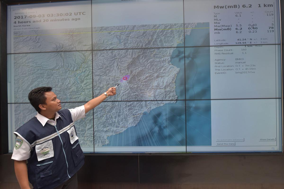 An Indonesian official at Indonesia's Meterological, Climatological and Geophysical Agency (BMKG) points to a map of North Korea showing where the agency recorded a 6.2 magnitude earthquake caused by a North Korean nuclear test on Sept. 3, 2017. (Adek Berry/AFP/Getty Images)