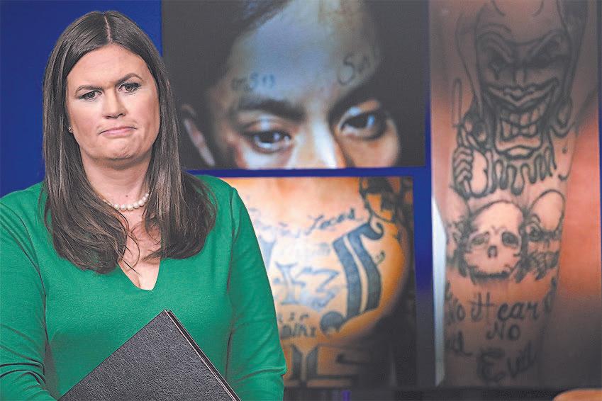 White House Press Secretary Sarah Sanders in front of photos of MS-13 gang members during a press briefing at the White House on July 27. (WIN MCNAMEE/GETTY IMAGES)