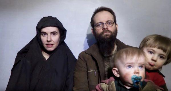 A still image from a video posted by the Taliban on social media on December 19, 2016, shows American Caitlan Coleman (L) speaking next to her Canadian husband Joshua Boyle and their two sons. (Courtesy Taliban/Social media via Reuters)