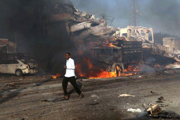 A man runs past the scene of an explosion in KM4 street in Hodan district of Mogadishu, Somalia on Oct. 14, 2017. (REUTERS/Feisal Omar)