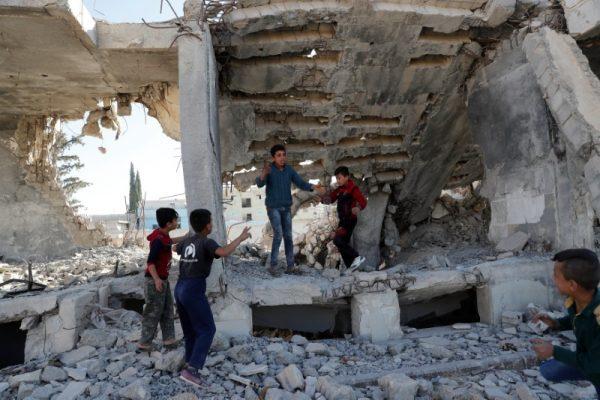 Children play at the ruins of a building destroyed in an air strike by coalition forces during fightings with ISIS terrorists in Kobani, Syria October 11, 2017. (Reuters/Erik De Castro)