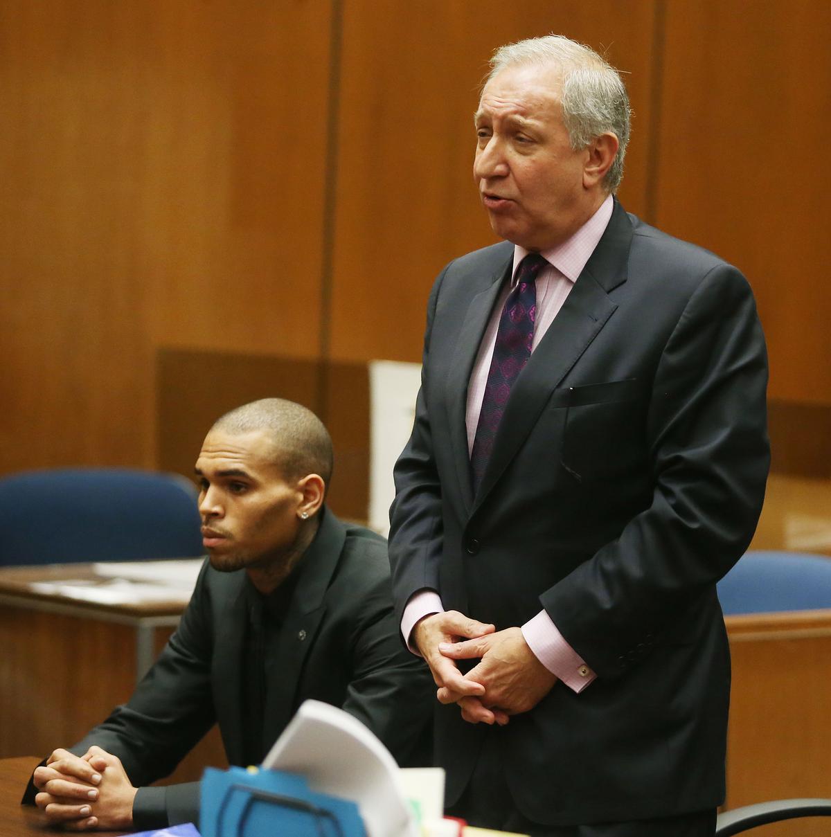 Recording artist Chris Brown (L) and his attorney Mark Geragos appear in Los Angeles court in Los Angeles, California, on Nov. 20, 2013. (Frederick M. Brown/Getty Images)