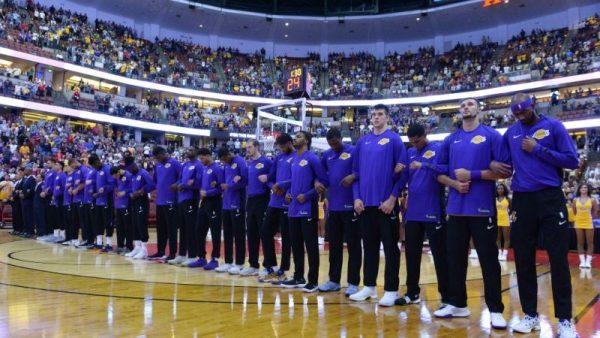The Los Angeles Lakers players lock arms during the national anthem before the start of the game against the Minnesota Timberwolves on September 30, 2017 at the Honda Center in Anaheim, California.  (Robert Laberge/Getty Images)