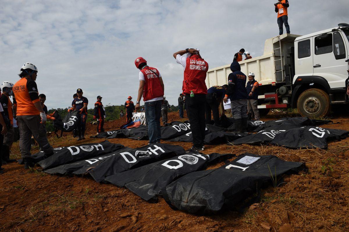 Rescue workers unload body bags containing the remains of victims of Marawi siege during a mass burial at a public cemetery in Marawi, in southern island of Mindanao on July 24, 2017, as the fighting between government troops and Muslim terrorists entered its second month. (TED ALJIBE/AFP/Getty Images)