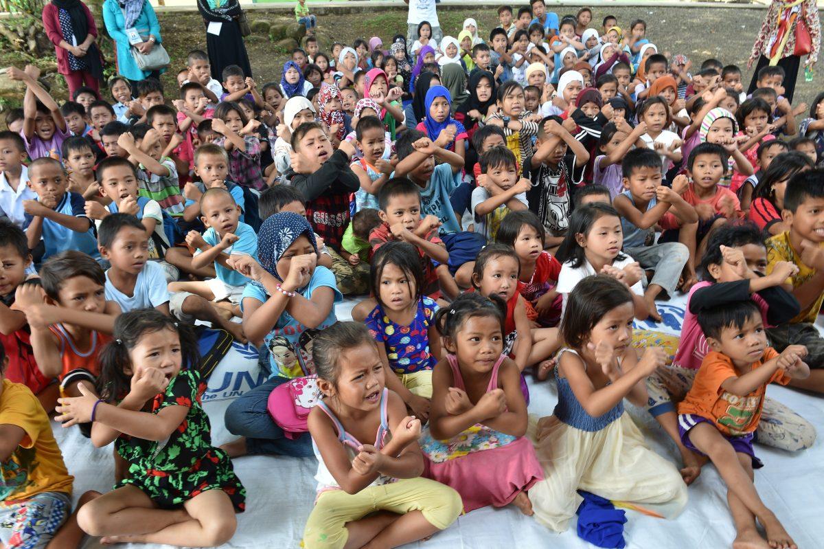 Displaced children from Marawi gesture the "X" signal to symbolise danger during a presentation on the dangers of bombs and unexploded ordnance by a Swiss Foundation for Mine Action volunteer at an evacuation centre in Balo-i, Lanao del norte province on the southern island of Mindanao on July 26, 2017, as they prepare the children and their families for their eventual return to their homes. (TED ALJIBE/AFP/Getty Images)