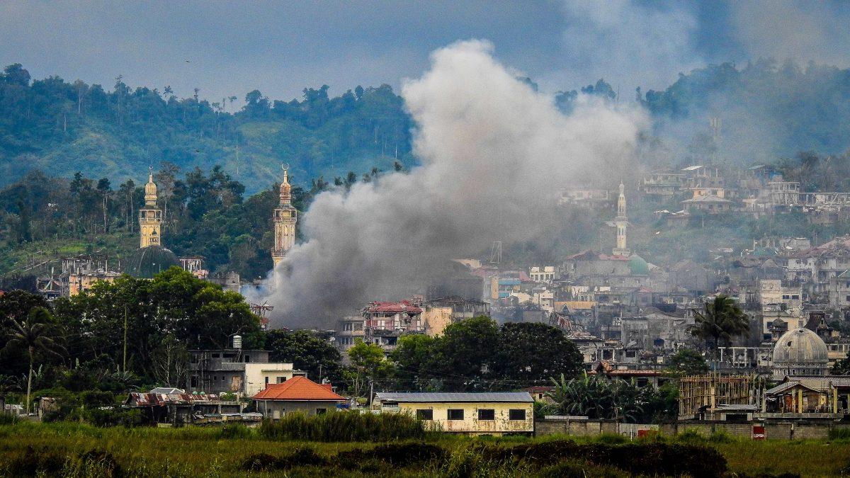Smoke billows from houses after aerial bombings by Philippine Airforce planes on Islamist terrorist positions in Marawi on the southern island of Mindanao on Sept. 17, 2017. (FERDINANDH CABRERA/AFP/Getty Images)