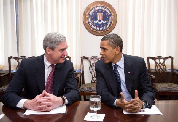 President Barack Obama speaks with FBI Director Robert Mueller during a meeting at FBI Headquarters in Washington on April 28, 2009. (SAUL LOEB/AFP/Getty Images)