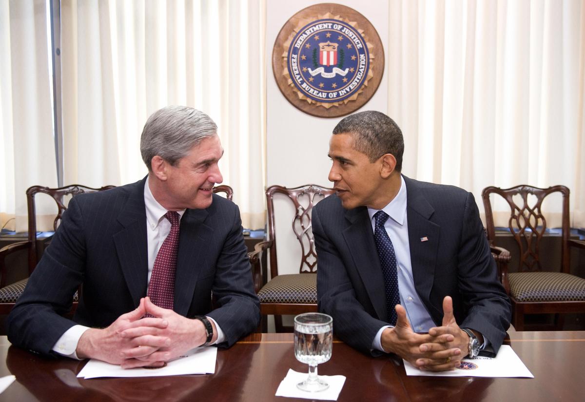 President Barack Obama speaks with FBI Director Robert Mueller during a meeting at FBI Headquarters in Washington, DC, April 28, 2009. Mueller headed the FBI for exactly 12 years, the second longest in history, following legislation in 2011 that extended his tenure by two years. (SAUL LOEB/AFP/Getty Images)