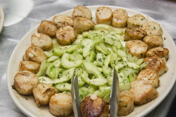 Scallops in garlic butter with cucumbers, a dish from southern Italy. (Annie Wu/The Epoch Times)