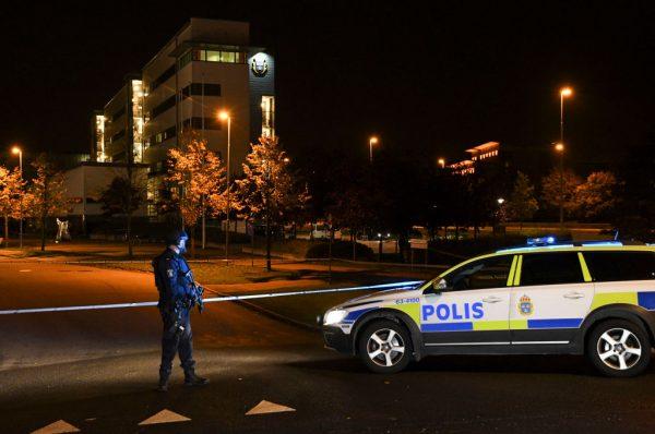 A police officer stands guard outside a security perimeter set around the area surrounding the police station in Helsingborg, on October 18, 2017, after a powerful explosion at the main entrance. (JOHAN NILSSON/AFP/Getty Images)
