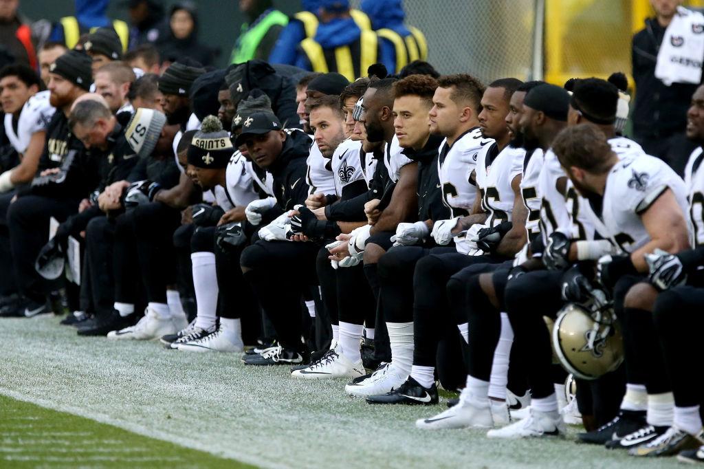 The New Orleans Saints kneel before the playing of the national anthem before the game against the Green Bay Packers at Lambeau Field in Green Bay, Wisconsin on Oct. 22, 2017. (Dylan Buell/Getty Images)