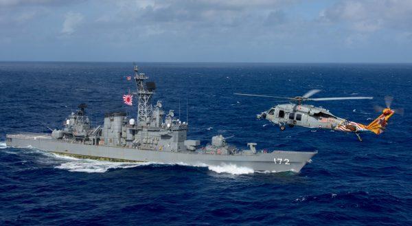 A U.S. MH-60S Sea Hawk flies by Japan's Maritime Self-Defense Force ship J.S. Shimakaze above waters around Okinawa southwest of the Korean peninsula on Oct. 9, 2017. (U.S. Navy via Reuters)