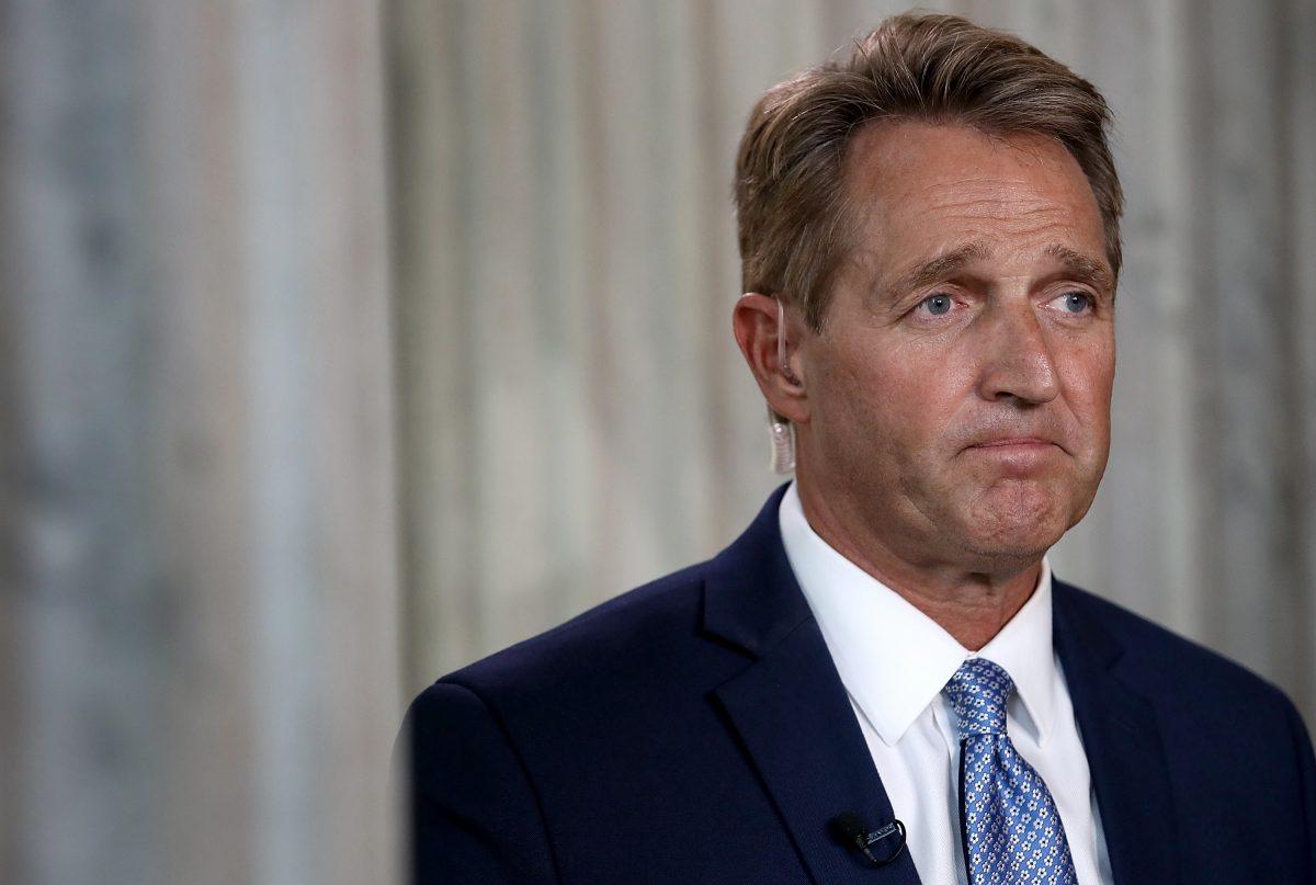 Sen. Jeff Flake speaks to reporters on Capitol Hill after announcing he will not seek re-election on Oct. 24, 2017. (Win McNamee/Getty Images)