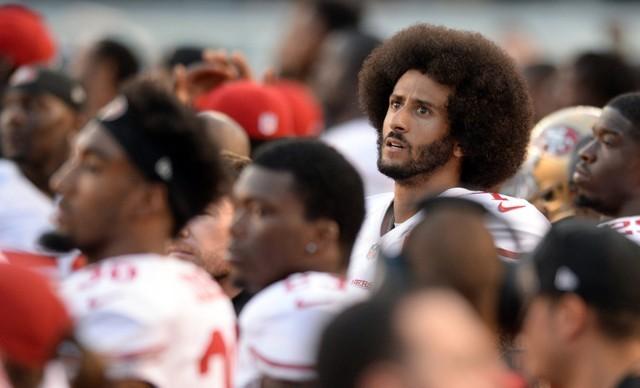 Colin Kaepernick (7) looks on before the national anthem against the San Diego Chargers at Qualcomm Stadium. (Jake Roth-USA TODAY Sports/Reuters)