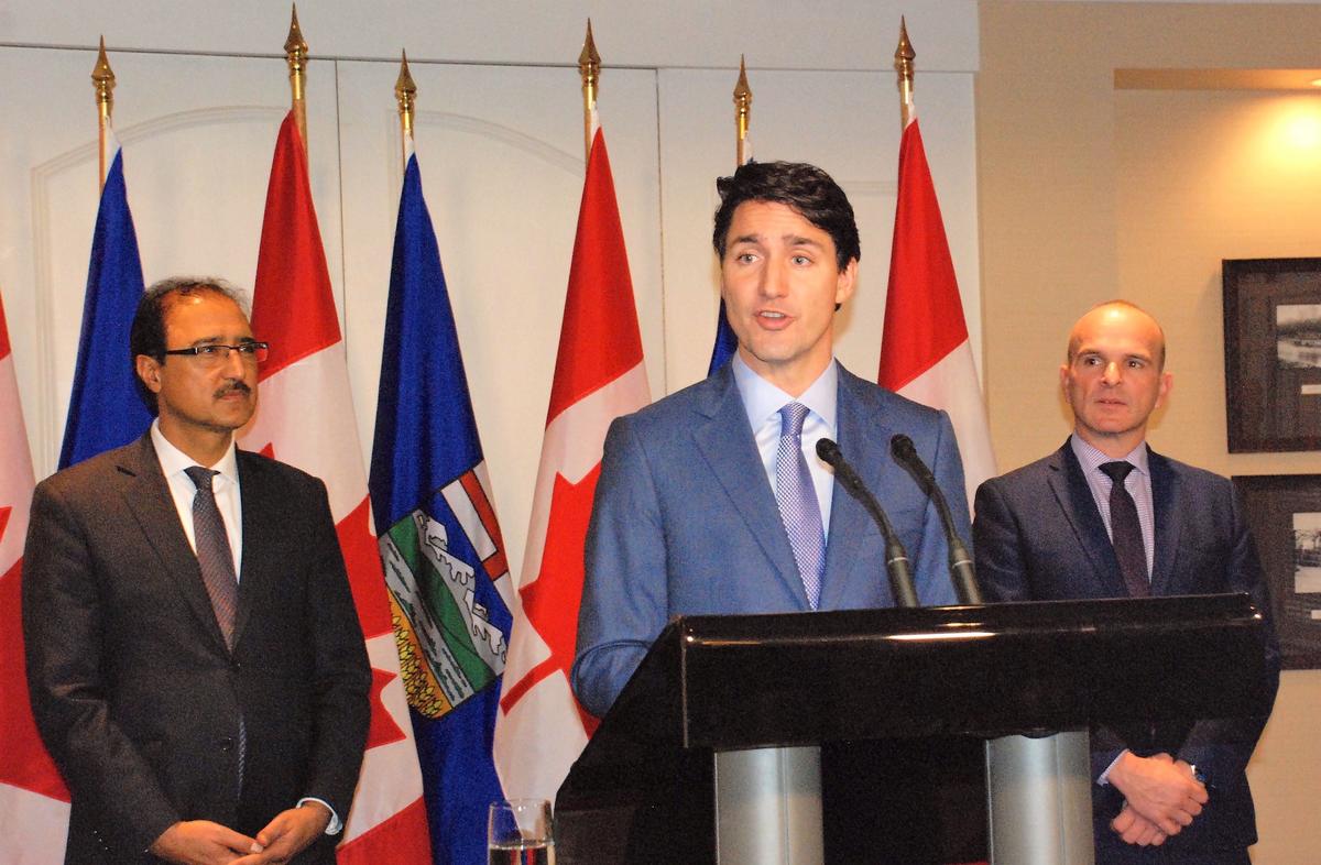 Prime Minister Justin Trudeau, joined by local Liberal MPs Amarjeet Sohi (L) and Randy Boissonnault, speaks at a press conference at Edmonton’s Fairmont Hotel MacDonald on Oct. 21, 2017. (Ping Shan/The Epoch Times)