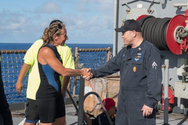 USS Ashland Command Master Chief Gary Wise welcomes aboard Jennifer Appel. (U.S. Navy photo by Mass Communication Specialist 3rd Class Jonathan Clay)
