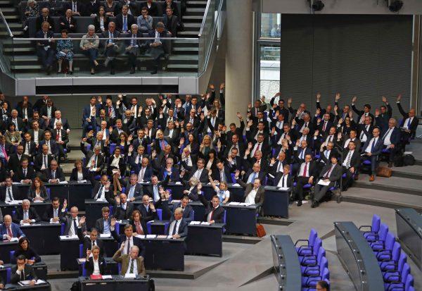 Members of the anti-immigration party Alternative for Germany (AfD) vote during the first plenary session of the German lower house of Parliament after a general election in Berlin on Oct. 24, 2017. (Fabrizio Bensch/Reuters)