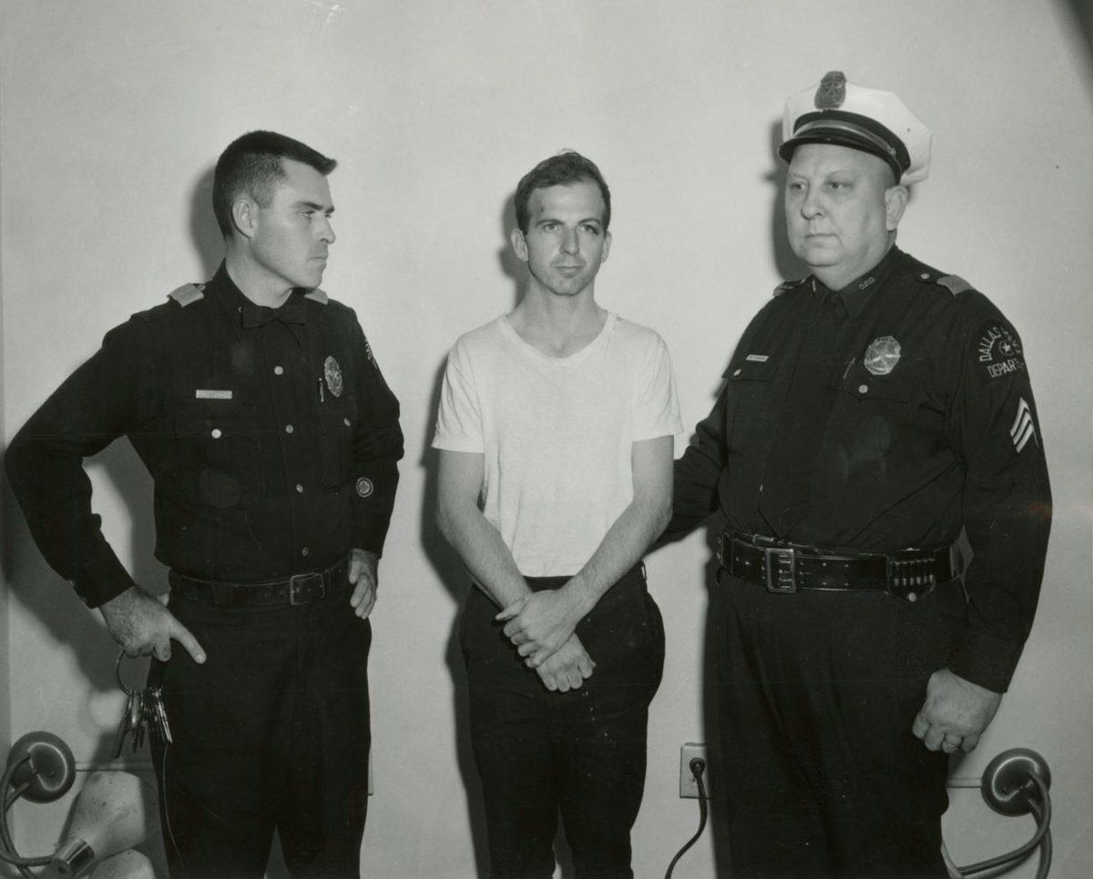 Lee Harvey Oswald, accused of assassinating former U.S. President John F. Kennedy, is pictured with Dallas police Sgt. Warren (R) and a fellow officer in Dallas, Texas in this handout image taken on Nov. 22, 1963. (Dallas Police Department/Dallas Municipal Archives/University of North Texas via Reuters)