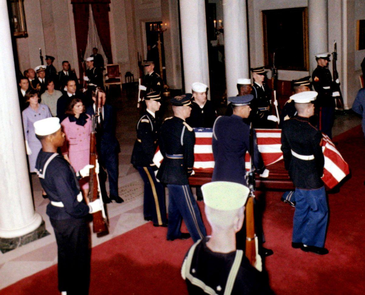 U.S. President John F. Kennedy's widow, first lady Jacqueline Bouvier Kennedy, and his brother U.S. Attorney General Robert F. Kennedy, walk into the White House grand foyer behind his casket upon its return from Dallas to Washington, DC in the early morning hours of Nov. 23, 1963. (JFK Library/The White House/Robert Knudsen/File Photo via REUTERS)