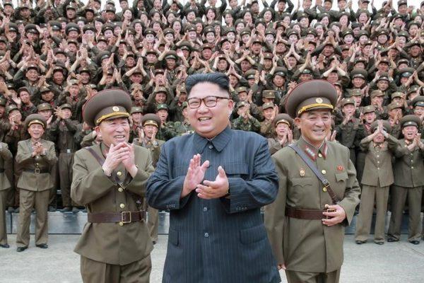 North Korean leader Kim Jong-un claps with military officers at the Command of the Strategic Force of the Korean People's Army in an unknown location in North Korea in this undated photo released by North Korea's Korean Central News Agency on Aug. 15, 2017. (KCNA/via Reuters)