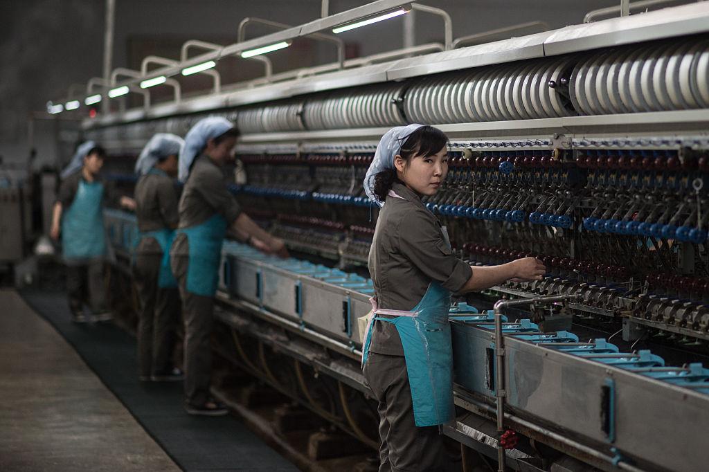 Workers operate machinery at a silk factory in Pyongyang on May 9, 2016. (ED JONES/AFP/Getty Images)