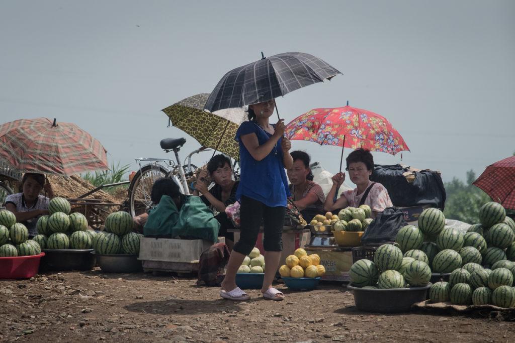 A group of women sell fruit beside a road on the outskirts of Sinchon, south of Pyongyang on July 24, 2017. (ED JONES/AFP/Getty Images)