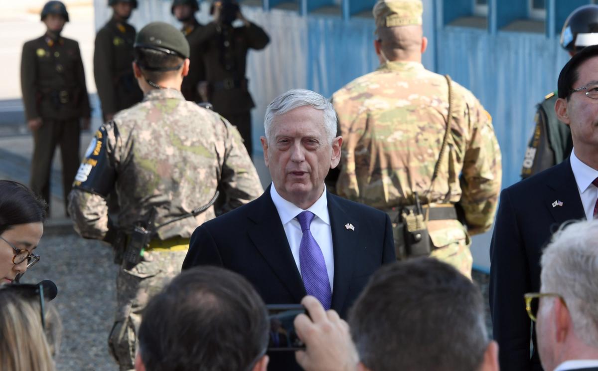 Defense Secretary Gen. Jim Mattis (C) speaks to the media as South Korean Defense Minister Song Young-Moo (R) looks on during a visit to the Demilitarized Zone. North Korean soldiers can be seen in the background. (JUNG YEON-JE/AFP/Getty Images)