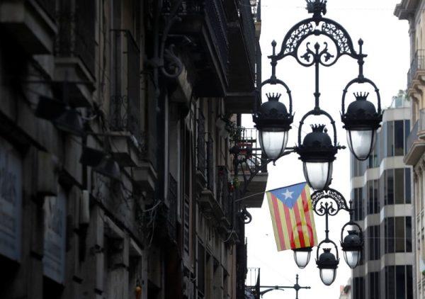 A Catalan flag hangs from a balcony the morning after the Catalan regional parliament declared independence from Spain in Barcelona, Spain, October 28, 2017. (Reuters/Yves Herman)