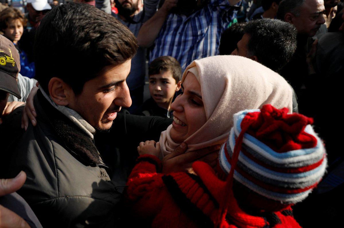 A relative reacts as she stands next to one of the hostages who escaped from his ISIS captors in Qaryatayn town in Homs province, Syria Oct. 29, 2017. (REUTERS/Omar Sanadiki)