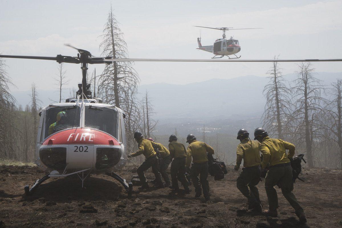 (L–R) Brendan McDonough (Miles Teller), Jesse Steed (James Badge Dale), Chris MacKenzie (Taylor Kitsch), Andrew Ashcraft (Alex Russell). A helicopter arrives to pick up the crew at the Chiricahua Mountains, in “Only the Brave," the true story of the Granite Mountain Hotshots. (Columbia Pictures/Richard Foreman/Sony Pictures Entertainment)