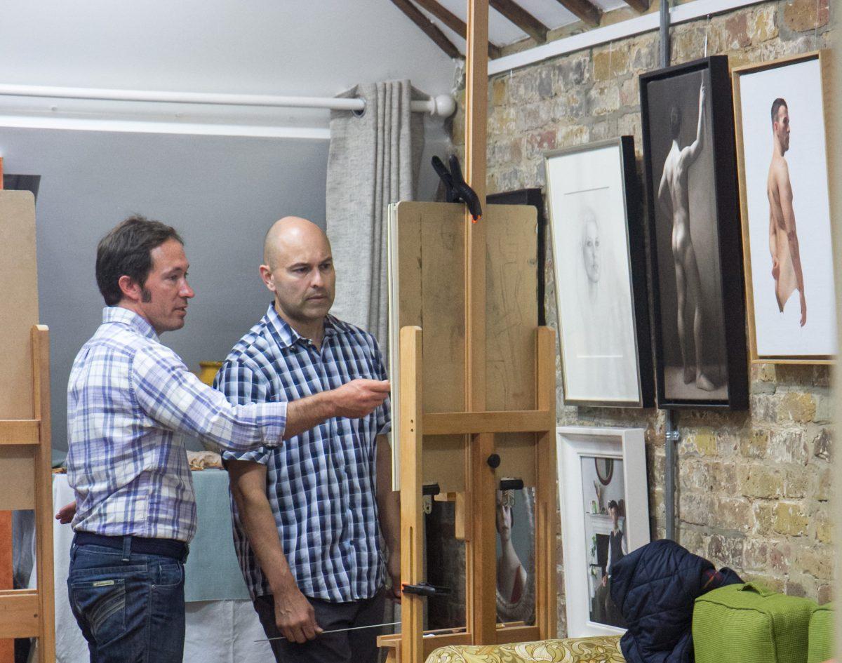 Travis Seymour reviews a student's work in his atelier in London on Sept. 12, 2017. (Milene Fernandez/The Epoch Times)